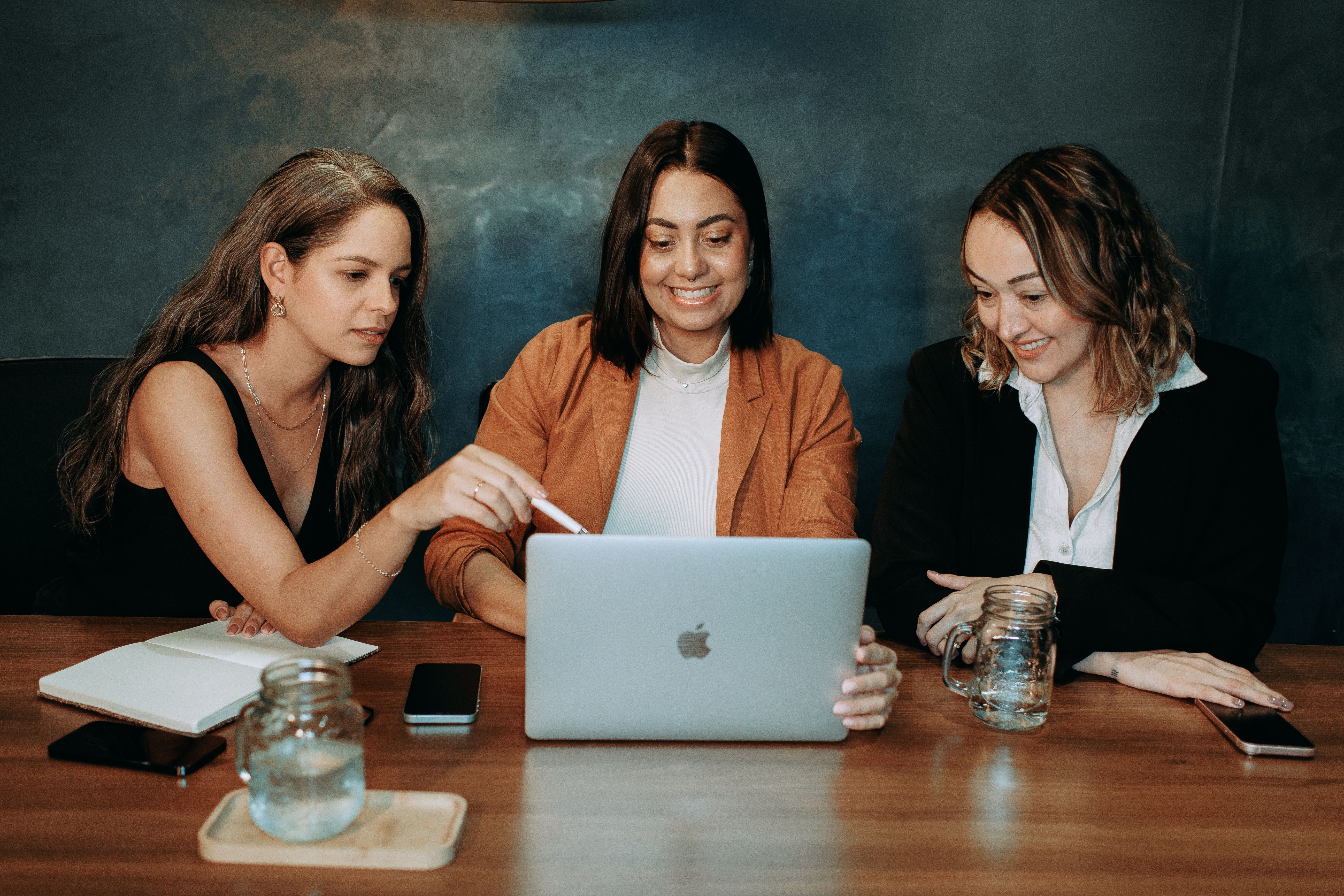 A hiring team reviewing a shortlist together around a laptop